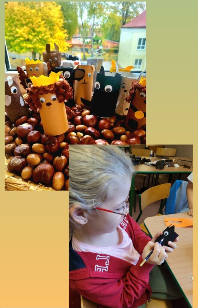 Zdj臋cie sk艂ada si臋 z kola偶u 2 zdj臋膰. Zdj臋cia na艂o偶one s膮 jedno na drugie, na zdj臋ciu pierwszym widoczne s膮 papierowe r贸偶nokolorowe pieski z rolek po papierze, kt贸re stoj膮 na stercie kasztan贸w i 偶o艂臋dzi umieszczonych w wiklinowym koszu. W tle wida膰 bia艂膮, plastikow膮 ram臋 okna , a za oknem, drzewa oraz fragment budynku. Na drugim zdj臋ciu jest prawy profil dziewczynki w czerwonych okularach i blond w艂osach, w r贸偶owej koszulce, a na niej ma czerwon膮 bluz臋. Dziewczynka siedzi na krze艣le i robi czarnego kota z rolki po papierze toaletowym. Po prawek stronie zdj臋cia widoczne s膮 dwa drewniane stoliki i krzes艂o, na kt贸rym wisi niebieska bluza. Na sto艂ach le偶膮 fragmenty kolorowych kartek papieru oraz przybory szkolne.