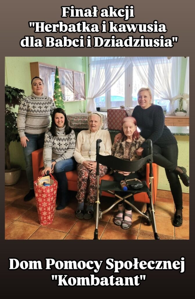 Zdjęcie przedstawia finał akcji "Herbatka i kawusia dla Babci i Dziadziusia", zorganizowanej w Domu Pomocy Społecznej "Kombatant". Na fotografii widzimy pięć osób, w tym dwie starsze kobiety, które są mieszkańcami domu pomocy, oraz trzy młodsze kobiety zaangażowane w organizację akcji. Jedna z kobiet trzyma w rękach torbę prezentową. W tle widać świąteczne dekoracje, co sugeruje, że wydarzenie odbywa się w okresie świątecznym. Cała grupa wygląda na szczęśliwą, co podkreśla serdeczną atmosferę spotkania.