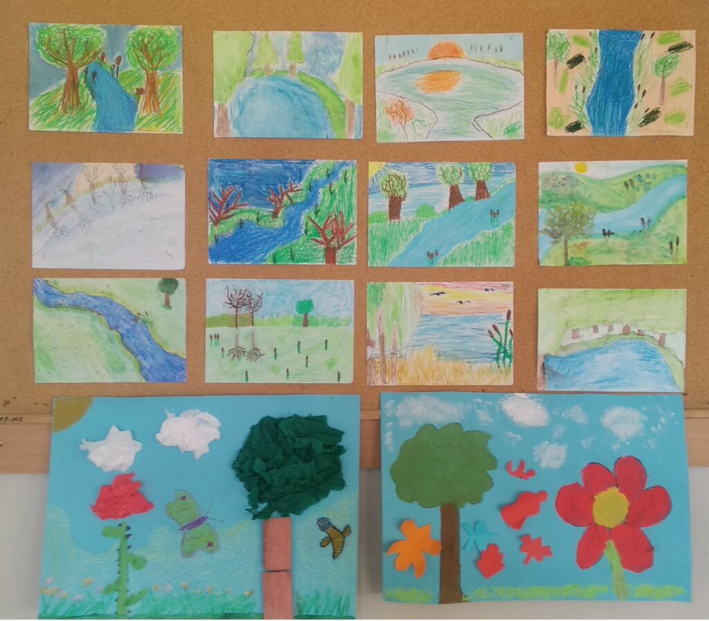 Na zdjęciu przedstawione są prace uczniów przestawiających krajobrazy. Prace ułożone są w trzech rzędach po 4 prace, które przedstawiają drzewa, krzewy i zarośla nad rzeką, a pod nimi znajduje się rząd z 2 pracami - z drzewami ,łąką , motylami i białymi obłokami.